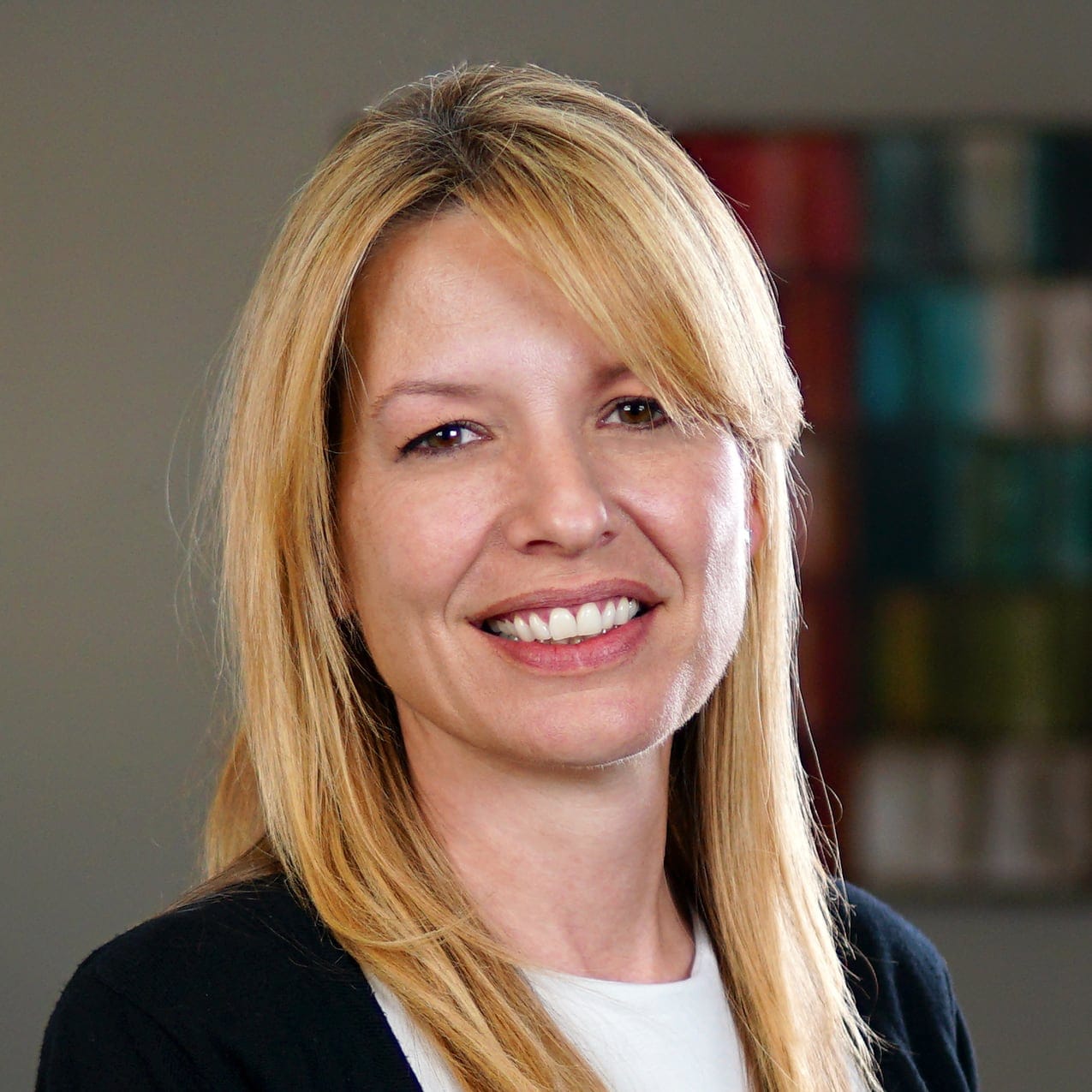 Smiling Sabri Blumberg against a blurred office background